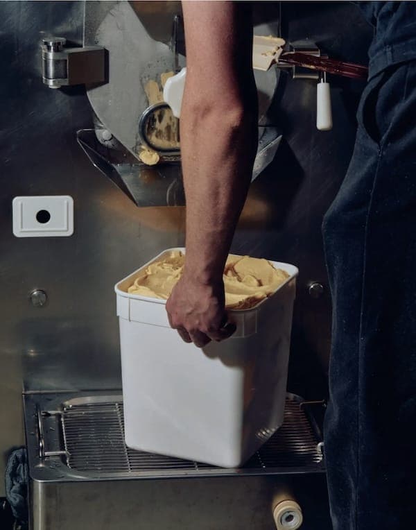 Food processing employee moving ingredients within a plant